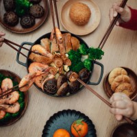 close-up of joyful three generations asian family having reunion dinner together in dining room and celebrating chinese new year at home. - food stock pictures, royalty-free photos & images