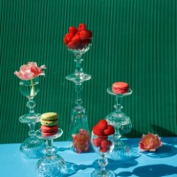 close-up of macarons and pink flowers on the green-blue background - food stock pictures, royalty-free photos & images