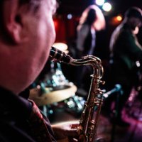 close-up of man playing saxophone on a live concert - concert stock pictures, royalty-free photos & images