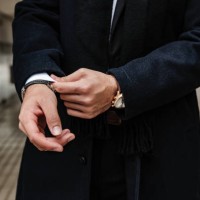 close-up of man's hands adjusting jacket sleeves in a modern urban setting. - fashion stock pictures, royalty-free photos & images