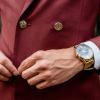 close-up of man wearing a suit and golden watch buttoning his jacket - fashion stock pictures, royalty-free photos & images