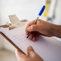 close-up of man writing on clipboard at construction site - home decoration stock pictures, royalty-free photos & images