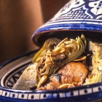 close-up of moroccan tajine with chicken, artichoke and nuts. - food stock pictures, royalty-free photos & images