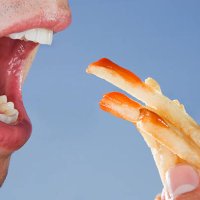close-up of someone eating french fries - junk food stock pictures, royalty-free photos & images