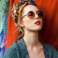 close-up of thoughtful stylish woman wearing sunglasses against fabric - fashion stock pictures, royalty-free photos & images
