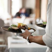 close-up of waiter walkiing with dishes - food stock pictures, royalty-free photos & images