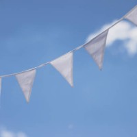 close-up of white flag garland against blue sky. garden party, summer festival, birthday party, baptism or wedding. - garden decoration stock pictures, royalty-free photos & images