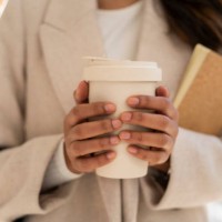 close-up of woman holding takeaway coffee - junk food stock pictures, royalty-free photos & images