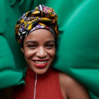 close-up of woman in headwear against green textile - fashion stock pictures, royalty-free photos & images