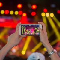 close-up of woman photographing music concert - concert stock pictures, royalty-free photos & images