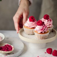 close-up of woman with delicious raspberry cupcakes in kitchen - home decoration stock pictures, royalty-free photos & images