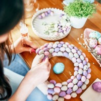 close-up of women's hands making a wreath of eggs for easter. - home decoration stock pictures, royalty-free photos & images