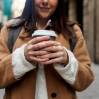 close-up of young woman with takeaway coffee in the city, barcelona, spain - junk food stock pictures, royalty-free photos & images
