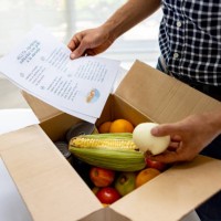 close-up on a man opening a food subscription box - food stock pictures, royalty-free photos & images