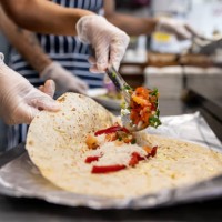 close-up on a waitress preparing quesadillas at a mexican restaurant - junk food stock pictures, royalty-free photos & images