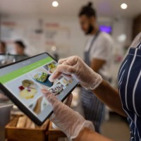 close-up on a waitress using a tablet to take an order at a restaurant - food stock pictures, royalty-free photos & images