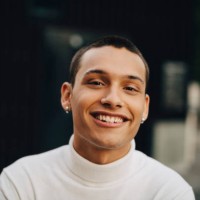 close-up portrait of smiling young man wearing turtleneck - fashion stock pictures, royalty-free photos & images