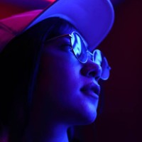 close-up portrait of young woman wearing sunglasses in darkroom - fashion stock pictures, royalty-free photos & images