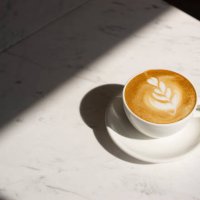 close up cappuccino cup with lighting and copy space - coffee stock pictures, royalty-free photos & images