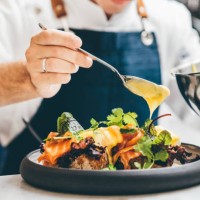 close up image of a chef preparing a gourmet dish. chef is decorating the plate just before the serving. - food stock pictures, royalty-free photos & images