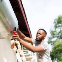 close up man using tools trying to fix hot water geyser - home decoration stock pictures, royalty-free photos & images