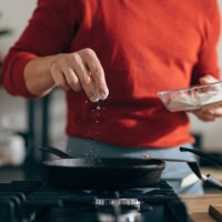 close up of anonymous man adding salt to a meal - food stock pictures, royalty-free photos & images
