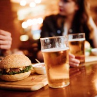 close up of burger and beer on a table - food stock pictures, royalty-free photos & images