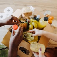 close up of couple donating food for poor people - food stock pictures, royalty-free photos & images