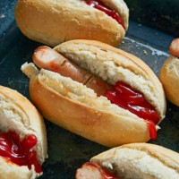 close up of frankfurters in hot dog roll as dissected fingers - junk food stock pictures, royalty-free photos & images