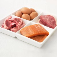 close up of sectioned plate with eggs, pork, salmon and steak - food stock pictures, royalty-free photos & images