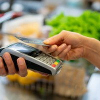 close up of unrecognizable customer doing a contactless payment at the supermarket - food stock pictures, royalty-free photos & images