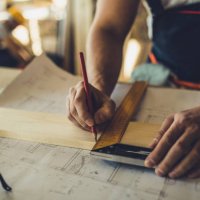 close up of unrecognizable worker drawing on wood plank. - home decoration stock pictures, royalty-free photos & images