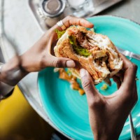 close up of woman eating vegan meal - food stockfoto's en -beelden
