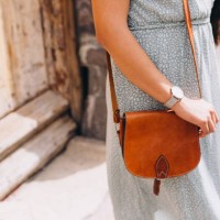 close up of woman gripping a small leather purse - fashion stock pictures, royalty-free photos & images