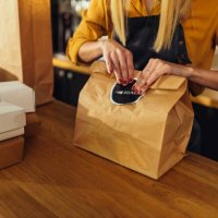 close up of woman packing food for delivery - junk food stock pictures, royalty-free photos & images