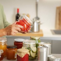 close up of woman,s hands holding a glass jar with preserved food - food stock pictures, royalty-free photos & images