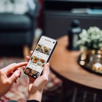 close up of young asian woman using meal delivery service and ordering food online with mobile app on smartphone while sitting on the sofa in the living room at a cozy home - junk food stock pictures, royalty-free photos & im
