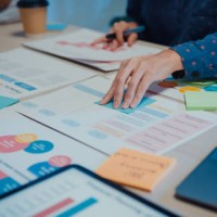 close up of young businesspeople meeting about new project with colleagues in conference room at night office. - fashion stock pictures, royalty-free photos & images