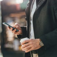 close up photo of man hands using a mobile phone outdoors - junk food stock pictures, royalty-free photos & images