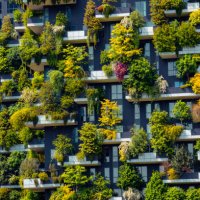 close up shot of modern skyscraper with green trees and colorful plants on balconies like a vertical forest in milano, italy - garden decoration stock pictures, royalty-free photos & images