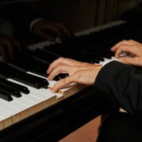 close up shot of the hands of an unrecognizable elegant pianist dressed in a suit playing a grand piano. - concert stock pictures, royalty-free photos & images