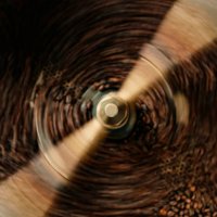 close up slow motion cooling batch spinning roasted coffee beans with a roasting machine - coffee stock pictures, royalty-free photos & images