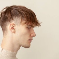 close up studio portrait of a caucasian young man in a beige longsleeve on a beige background - hairstyle stock pictures, royalty-free photos & images
