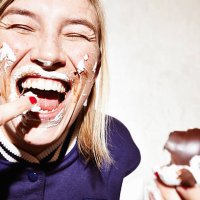 close up studio shot of young woman with face covered in chocolate marshmallow - food stock pictures, royalty-free photos & images