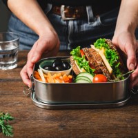 closeup of a woman making a healthy lunch box - junk food stock pictures, royalty-free photos & images