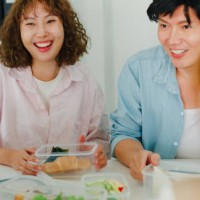 closeup of cheerful asian team enjoys a sustainable lunch break in the office, highlighting environmental responsibility and social inclusion. esg sustainable business office. - junk food stock pictures, royalty-free photos &