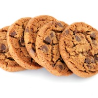 closeup of chocolate chip cookies isolated on white - junk food stock pictures, royalty-free photos & images