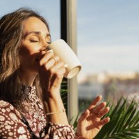 closeup portrait of woman drinking coffee in the morning at home - coffee stock pictures, royalty-free photos & images