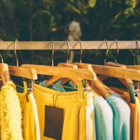 clothes hang on a shelf in a designer clothes store - fashion stock pictures, royalty-free photos & images