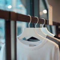 clothes hanging on rack in fashion store - fashion stock pictures, royalty-free photos & images